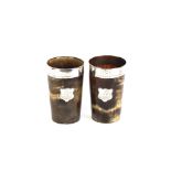 Two Antique horn beakers, having white metal mounts and shield plaques with finely scrimmed motifs