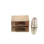 An Asprey of London 9 carat gold matchbox holder, approx. 16.7gms; and a small silver thimble, (2)