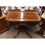 A Regency rosewood and brass inlaid card table, with foldover swivel top, raised on a turned