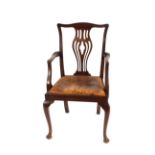 A set of eight mahogany Chippendale design dining chairs, six standards and two elbows