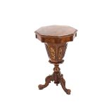 A Victorian walnut octagonal trumpet shaped work table, the hinged lid opening to reveal interior