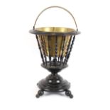 A Dutch ebonised basket, having brass liner, raised on circular base and turned feet, 37cm dia.