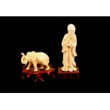 An Antique carved ivory figure of an immortal, carrying a gourd and staff, on wooden plinth; an