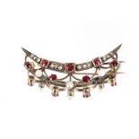 A 9 carat gold crescent bar brooch, set with rubies and diamonds