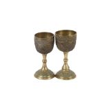 Two Eastern gilt metal goblets, with floral decoration, indistinct script to bases