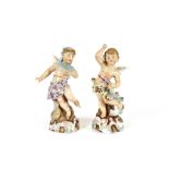 A pair of Continental porcelain figures, depicting cherubs, 25cm high