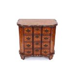 An 18th Century Dutch marquetry commode, of serpentine shape, profusely decorated with trailing