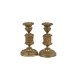 A pair of mid 19th Century gilt metal dwarf candlesticks, with guilloche and foliate designs, 15cm