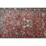 A Kashan type rug, with allover floral decoration on a pink and blue ground, 202cm x 130cm