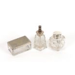 A cut glass and silver mounted inkwell; a cut glass perfume atomiser; and an oblong cut glass tidy