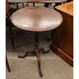 A Georgian mahogany occasional table, with circular dished top, raised on turned column and tripod