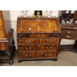 An 18th Century walnut bureau, the fall front opening to reveal an interior arrangement of