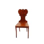 A Regency mahogany hall chair, having shield shaped back, raised on sabre supports