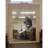 Regency style carved and decorated country house mirror, with scroll arch pediment above a classical