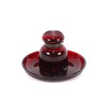 A Victorian ruby glass inkwell, on circular dished stand, 19cm dia.