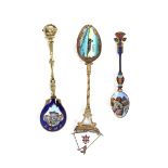 An enamel decorated spoon, the bowl with decoration of Gibraltar; another decorated Rome and a