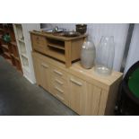 A light oak effect sideboard; together with a ligh