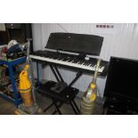 A Rolland EP.9E digital piano on stand and stool