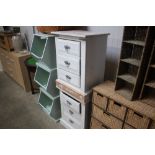 A pair of white painted pine three drawer bedside