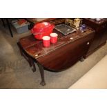 A 19th Century mahogany drop leaf table raised on