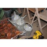 Three galvanized watering cans