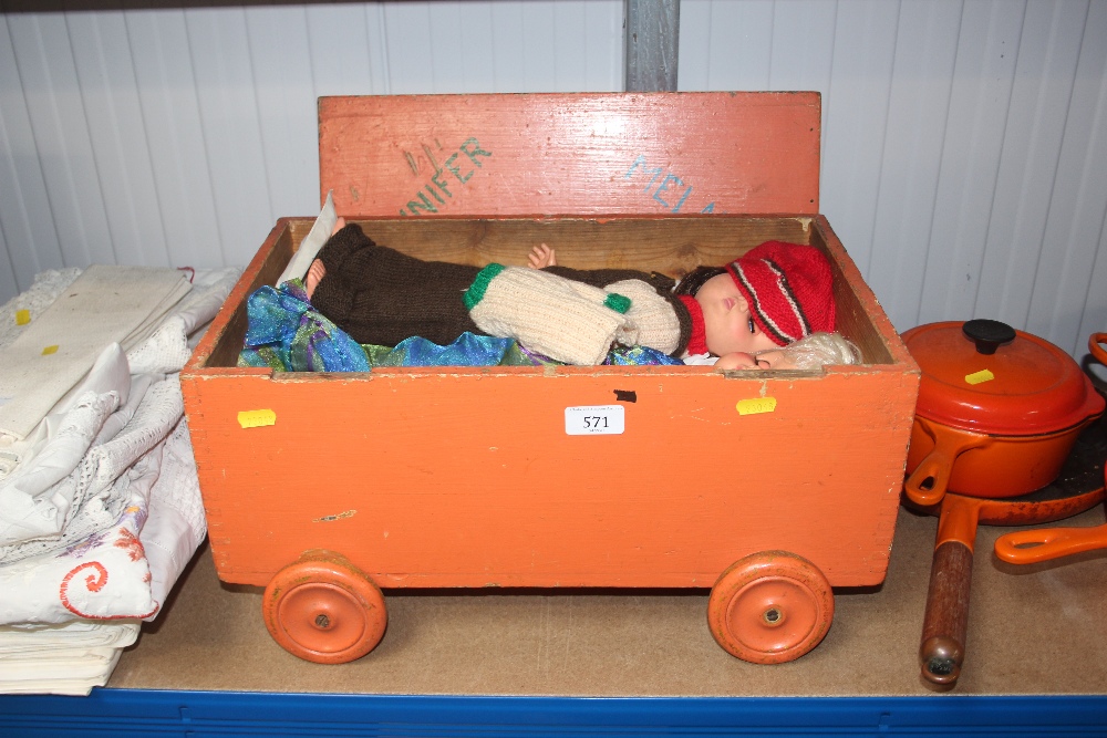 A painted wooden chest and contents of dolls