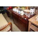 A reproduction mahogany cabinet fitted two drawers