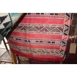 An approx 5'2" x 2'8" red patterned Kelim runner