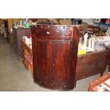 A Georgian mahogany corner cupboard