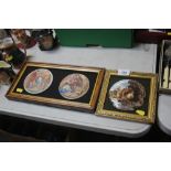 Three framed circular plaques contained in two fra