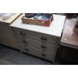 A grey painted chest fitted three drawers