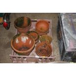 A plastic tray of terracotta planters