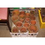 A plastic tray of terracotta planters
