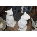 A pair of concrete garden ornaments in the form of