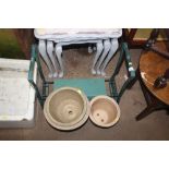 A garden kneeler and three glazed planters