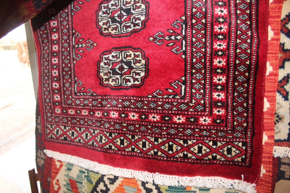 An approx. 3'3" x 2'1" red Eastern patterned rug