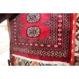 An approx. 3'3" x 2'1" red Eastern patterned rug