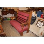 A heavy carved oak and upholstered bench