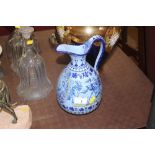 A continental pottery blue glazed jug decorated wi