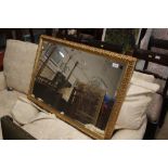 A gilt framed and etched glass wall mirror