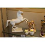 A Keiser white glazed horse; a Goebel figure group
