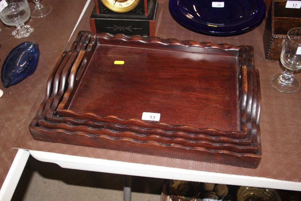 A nest of four hardwood graduating trays