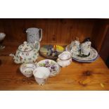 A floral decorated teapot, two dog ornaments, an E