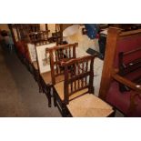 Four oak spindle back and rush seated chairs