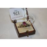 A yellow metal pink and white stone set ring