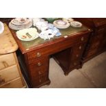 A mahogany writing desk with green leather inset t