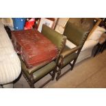 A pair of green leather and oak carver chairs