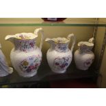 A set of three mid-19th Century floral painted jug