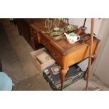 A walnut writing table with brown leather inset to