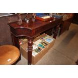 A Victorian mahogany serving table raised on turne